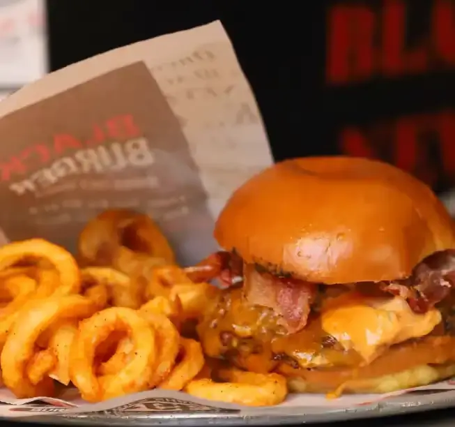 A Bacon, Smash Cheese Burger with Onion Rings from Black Burger, takaway in NY